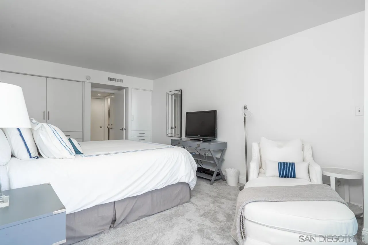 1770 Avenida Del Mundo, Unit 701 Coronado, CA 92118 - Photo 11 of 17 a bedroom with a bed and a flat screen tv