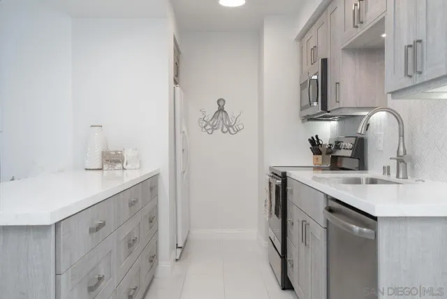 a kitchen with a sink and cabinets