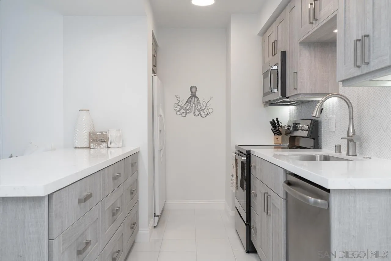 1770 Avenida Del Mundo, Unit 701 Coronado, CA 92118 - Photo 3 of 17 a kitchen with a sink and cabinets
