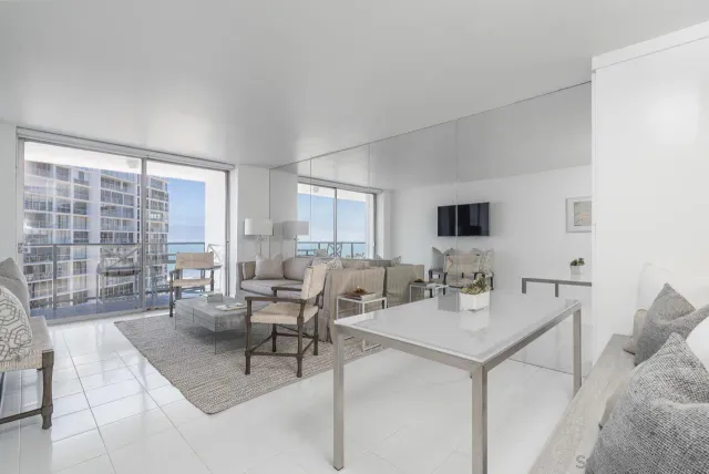 a living room with furniture and a large window