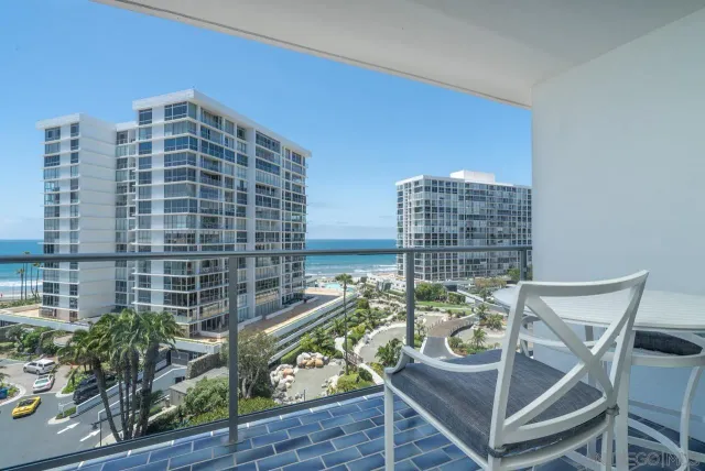 a view of a balcony with two chairs and a table