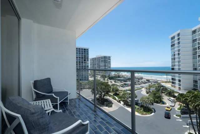 a balcony with a potted plant and outdoor seating