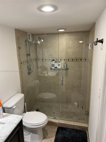 a bathroom with a shower a toilet and a sink
