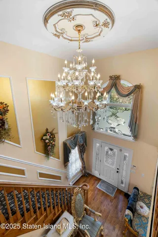 a bedroom with furniture and a chandelier