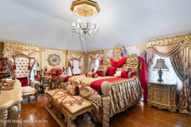 a bedroom with furniture and a chandelier