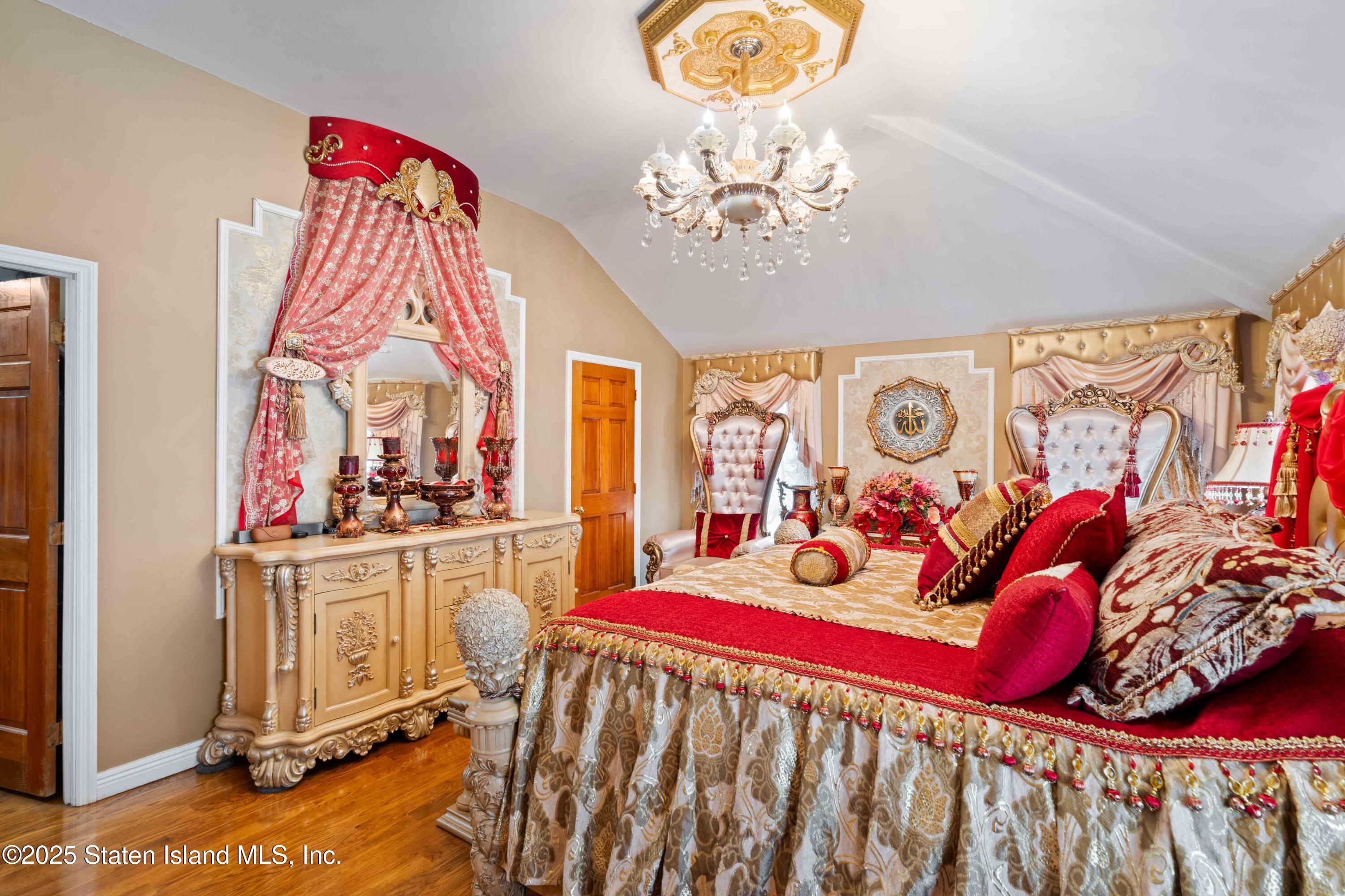 287 Rensselaer Avenue Staten Island, NY 10312 - Photo 21 of 35 a bedroom with furniture and a chandelier