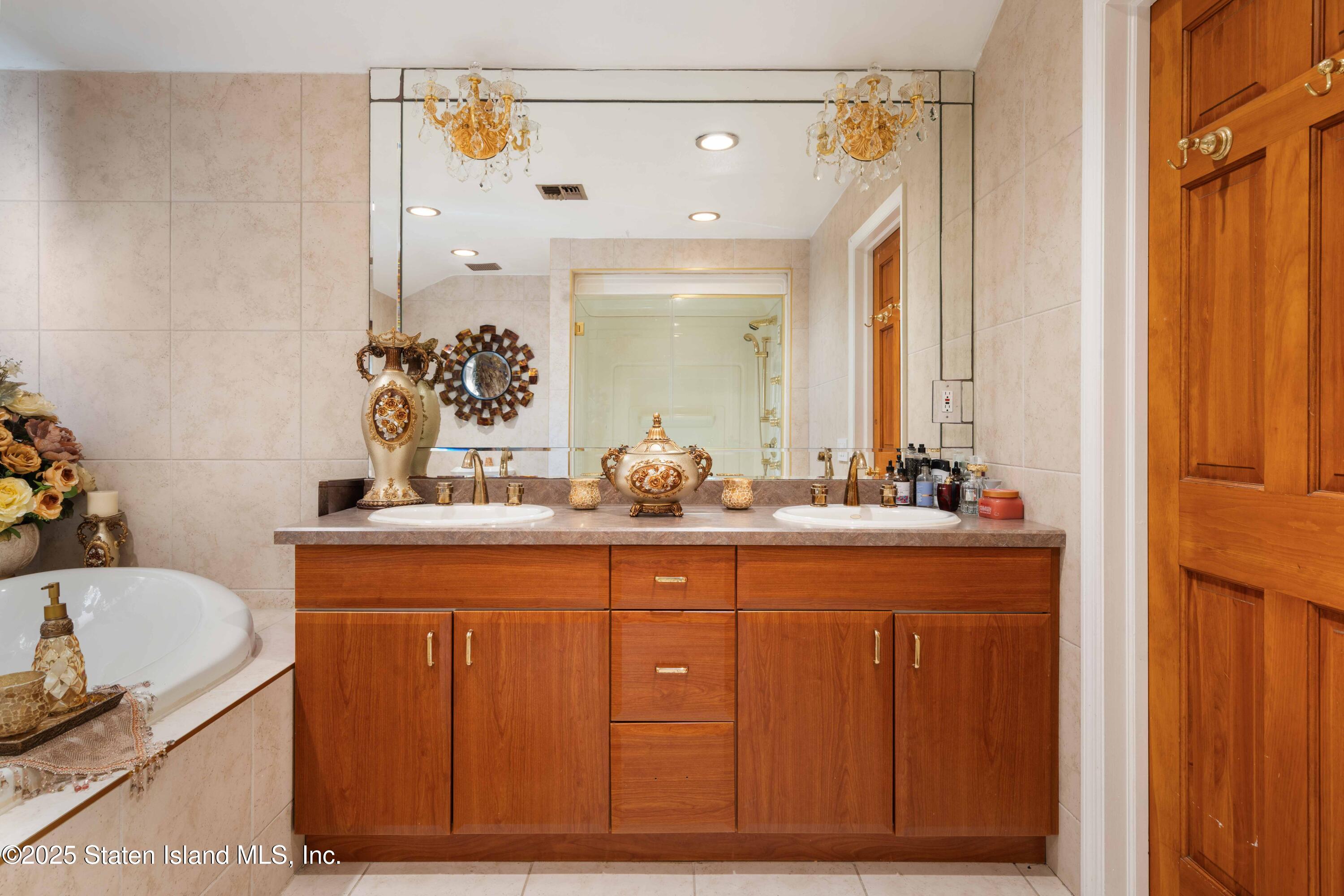 287 Rensselaer Avenue Staten Island, NY 10312 - Photo 24 of 35 a bathroom with a granite countertop sink and a mirror