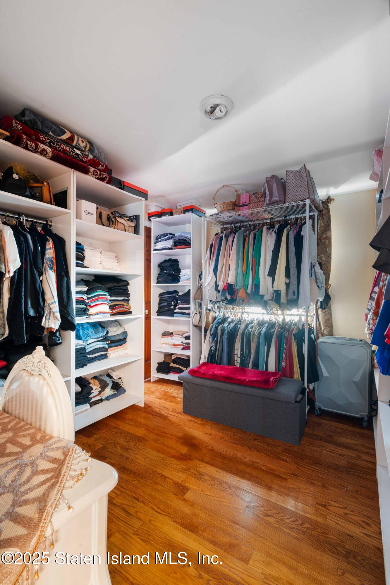 287 Rensselaer Avenue Staten Island, NY 10312 - Photo 25 of 35 a view of walk in closet with clothes and shoes