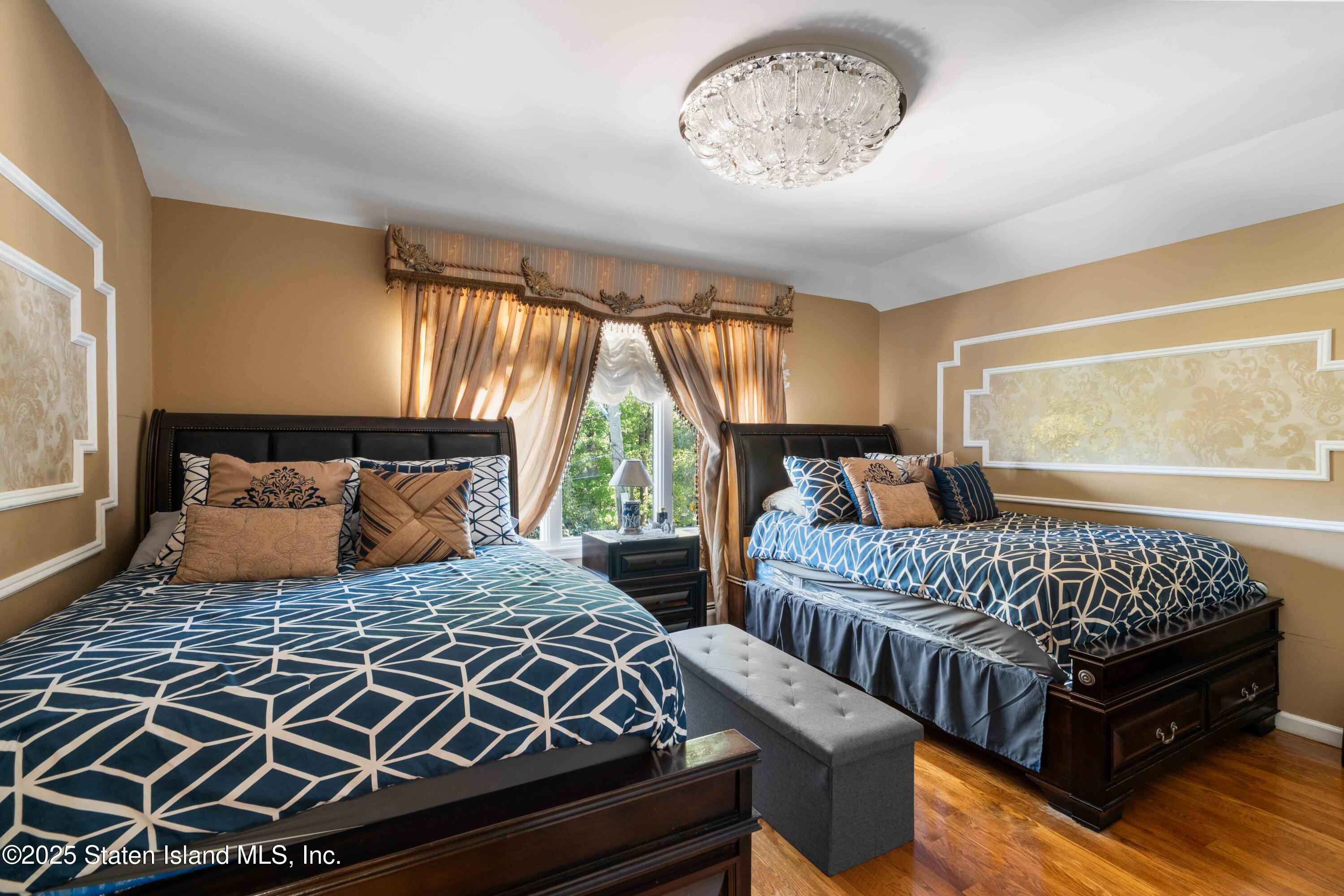 287 Rensselaer Avenue Staten Island, NY 10312 - Photo 27 of 35 a bedroom with double bed windows and a chandelier