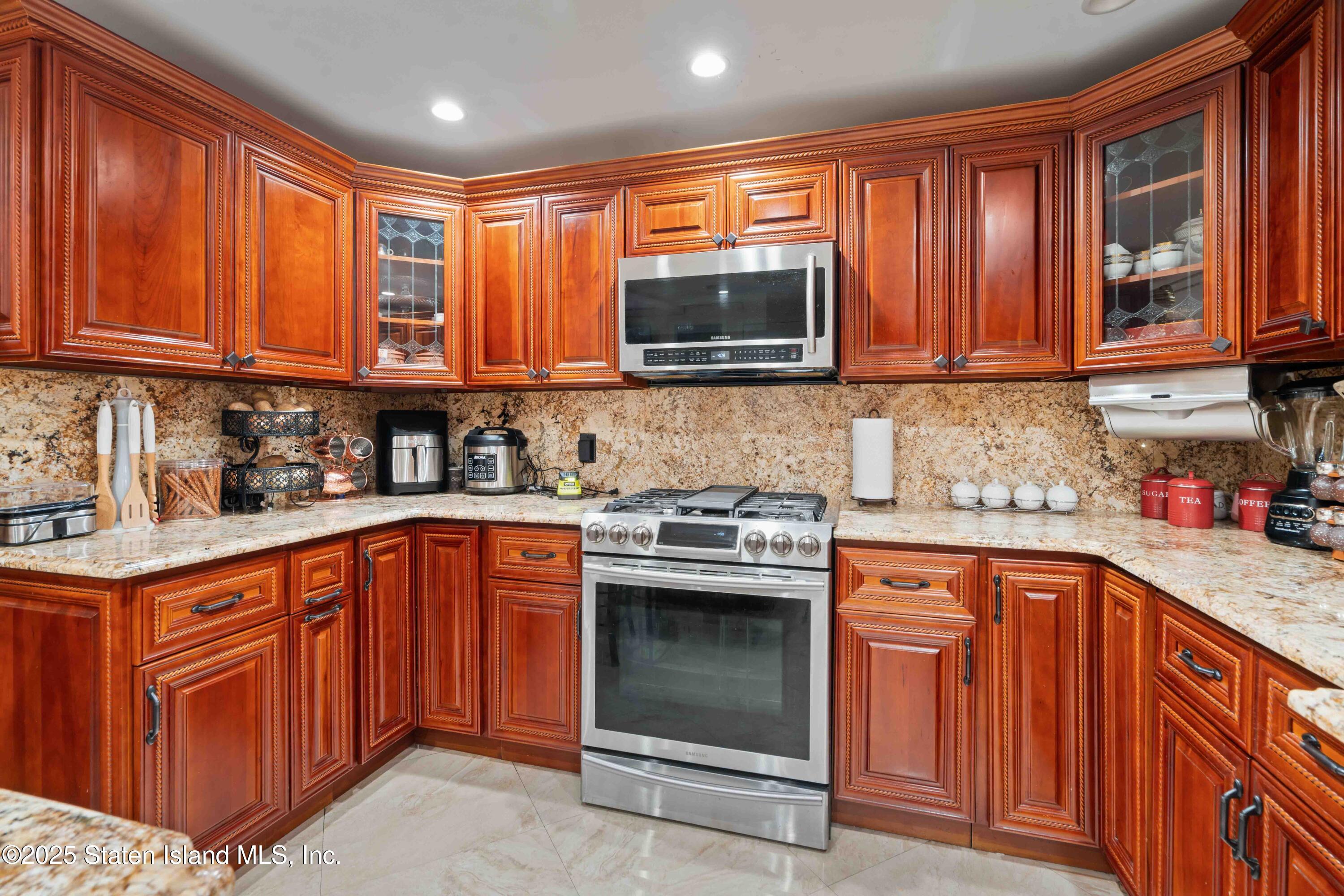 287 Rensselaer Avenue Staten Island, NY 10312 - Photo 31 of 35 a kitchen with stainless steel appliances granite countertop a stove sink microwave and cabinets