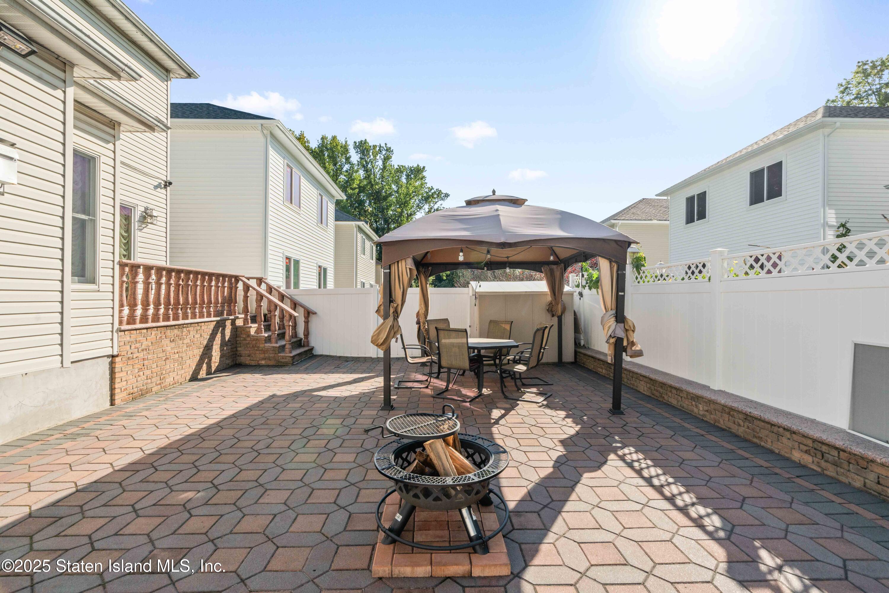 287 Rensselaer Avenue Staten Island, NY 10312 - Photo 5 of 35 a view of a patio with table and chairs near a barbeque