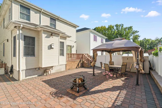 a building outdoor space with patio furniture and potted plants