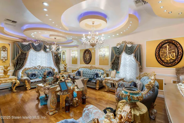 a living room with lots of furniture and a chandelier