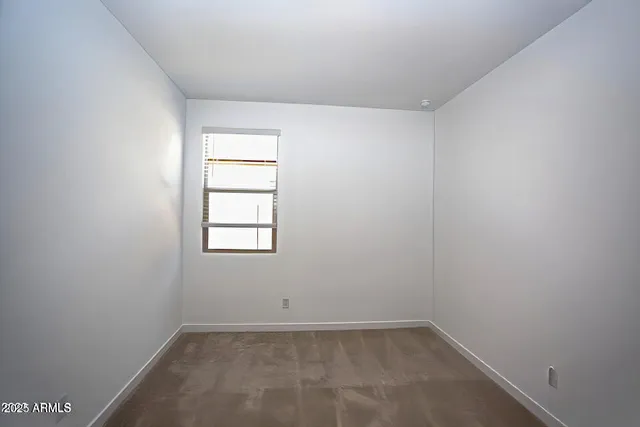 a bathroom with a granite countertop sink toilet a mirror and shower