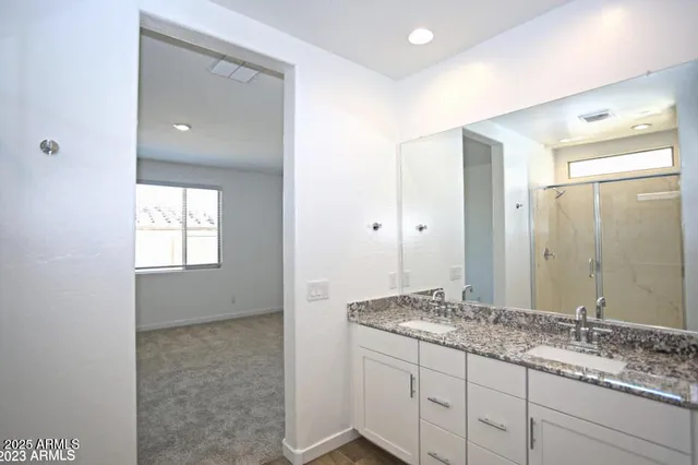 a bathroom with a glass shower door