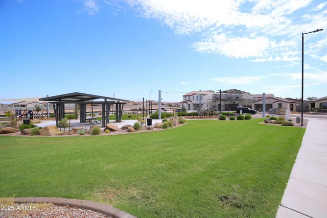a view of a backyard with swimming pool