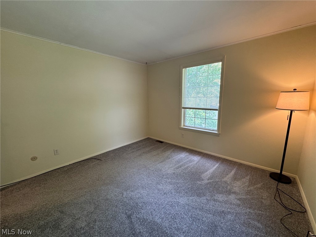 7294 Fox Mill Road, Unit 19D Mentor, OH 44060 - Photo 24 of 27 Interior room featuring light-colored walls and grey carpet