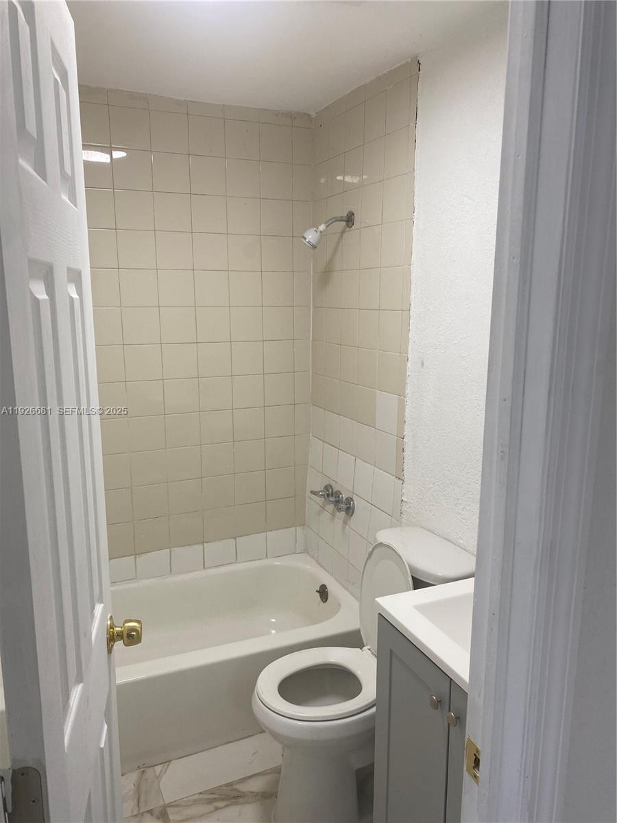 2122 Northwest 5th Street Pompano Beach, FL 33069 - Photo 21 of 53 a bathroom with a sink a toilet and shower