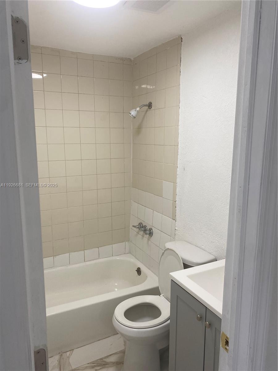 2122 Northwest 5th Street Pompano Beach, FL 33069 - Photo 23 of 53 a bathroom with a bathtub and a toilet