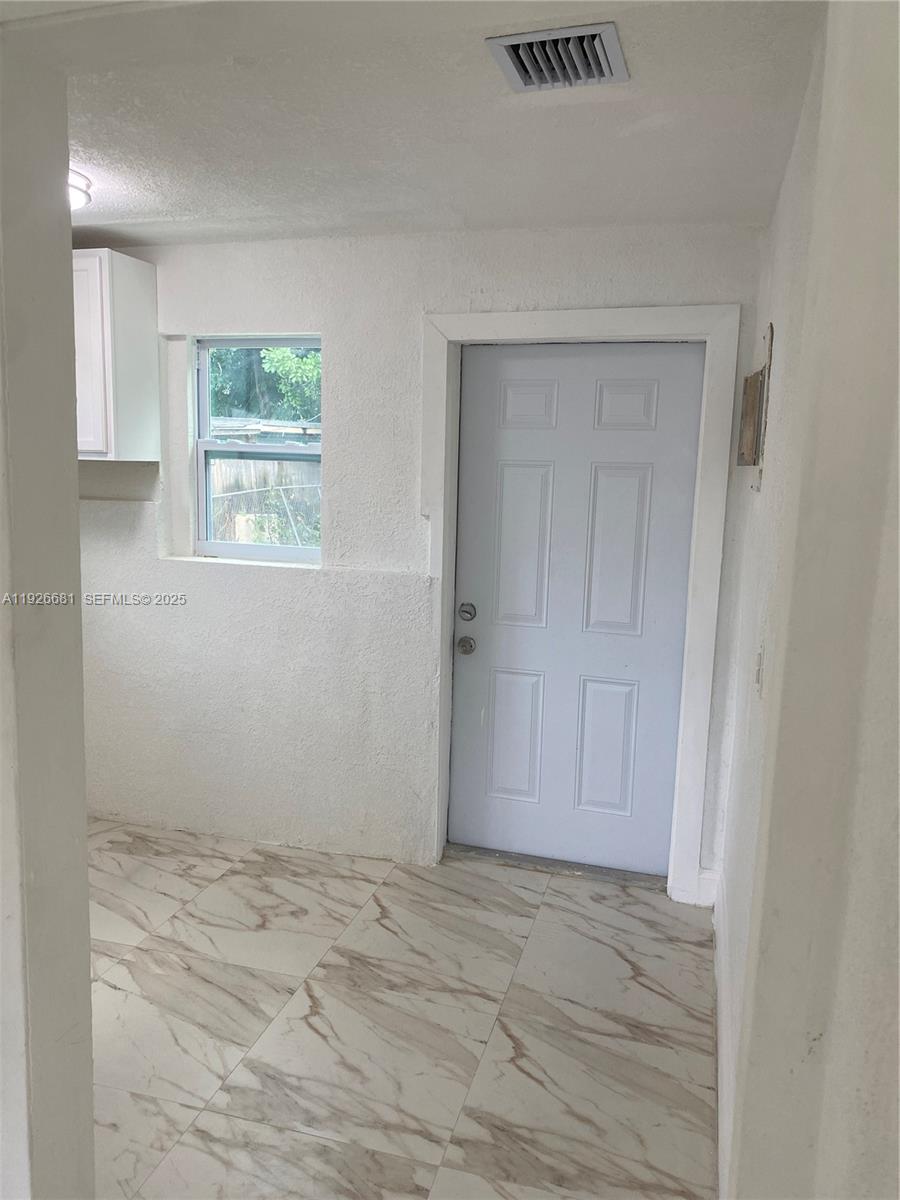 2122 Northwest 5th Street Pompano Beach, FL 33069 - Photo 25 of 53 an empty room with a window