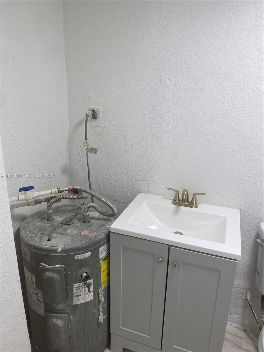 2122 Northwest 5th Street Pompano Beach, FL 33069 - Photo 30 of 53 a sink sitting inside of a bathroom