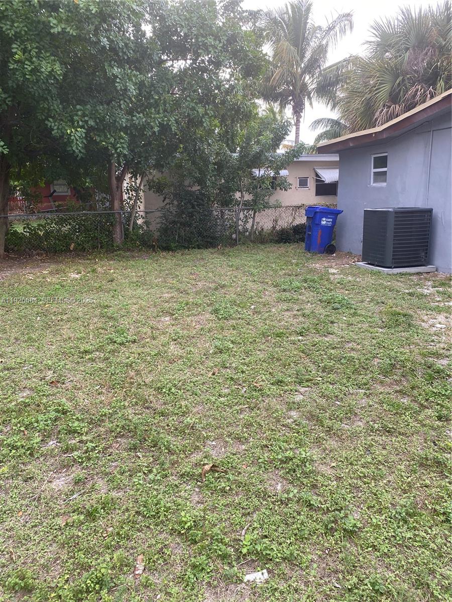 2122 Northwest 5th Street Pompano Beach, FL 33069 - Photo 46 of 53 a view of a backyard with table and chairs and wooden fence