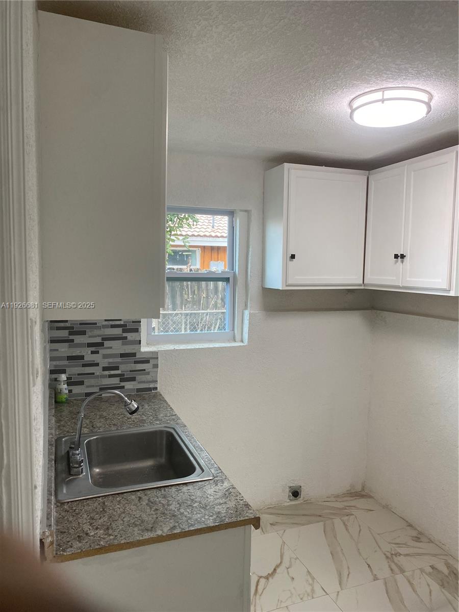 2122 Northwest 5th Street Pompano Beach, FL 33069 - Photo 5 of 53 a kitchen with a sink and cabinets