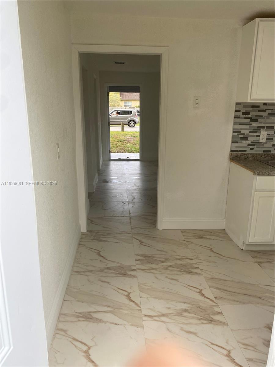 2122 Northwest 5th Street Pompano Beach, FL 33069 - Photo 6 of 53 a view of a hallway with a white doors
