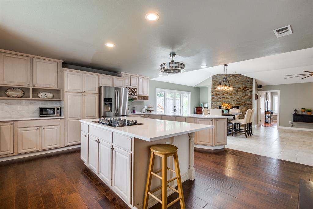 a kitchen with stainless steel appliances granite countertop a stove oven and a refrigerator