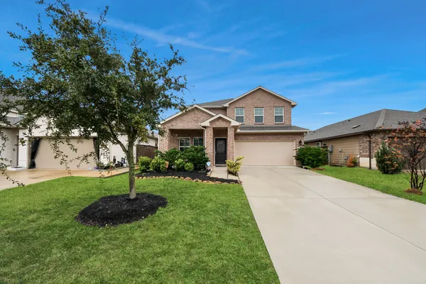 a front view of a house with a yard and garage