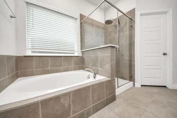 a bathroom with a double vanity sink mirror and shower