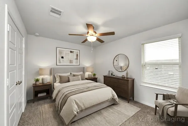 a view of a livingroom with a ceiling fan and a bathroom