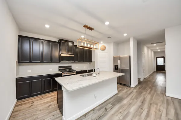 a living room with furniture flat screen tv and a large window