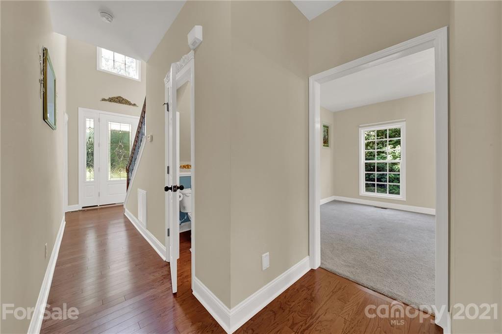 1185 Reservation Road Rock Hill, SC 29730 - Photo 15 of 47 a view of a hallway with wooden floor and a living room
