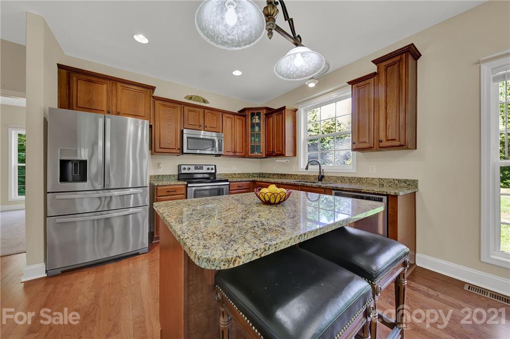 1185 Reservation Road Rock Hill, SC 29730 - Photo 16 of 47 a kitchen with stainless steel appliances granite countertop a sink refrigerator and microwave