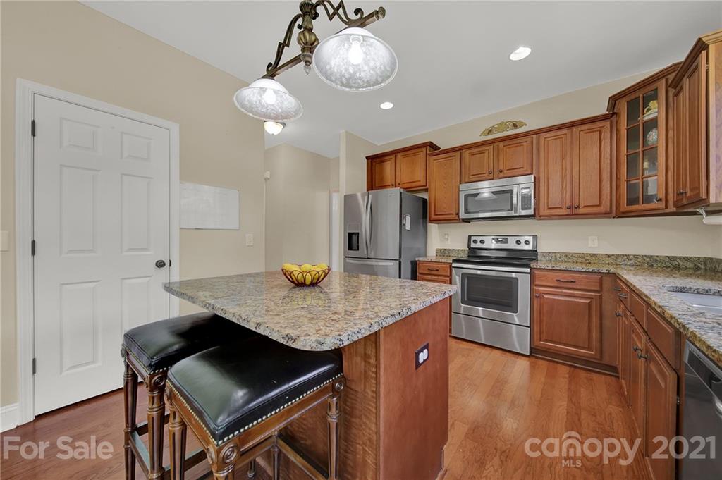 1185 Reservation Road Rock Hill, SC 29730 - Photo 18 of 47 a kitchen with stainless steel appliances granite countertop a stove refrigerator sink and cabinets