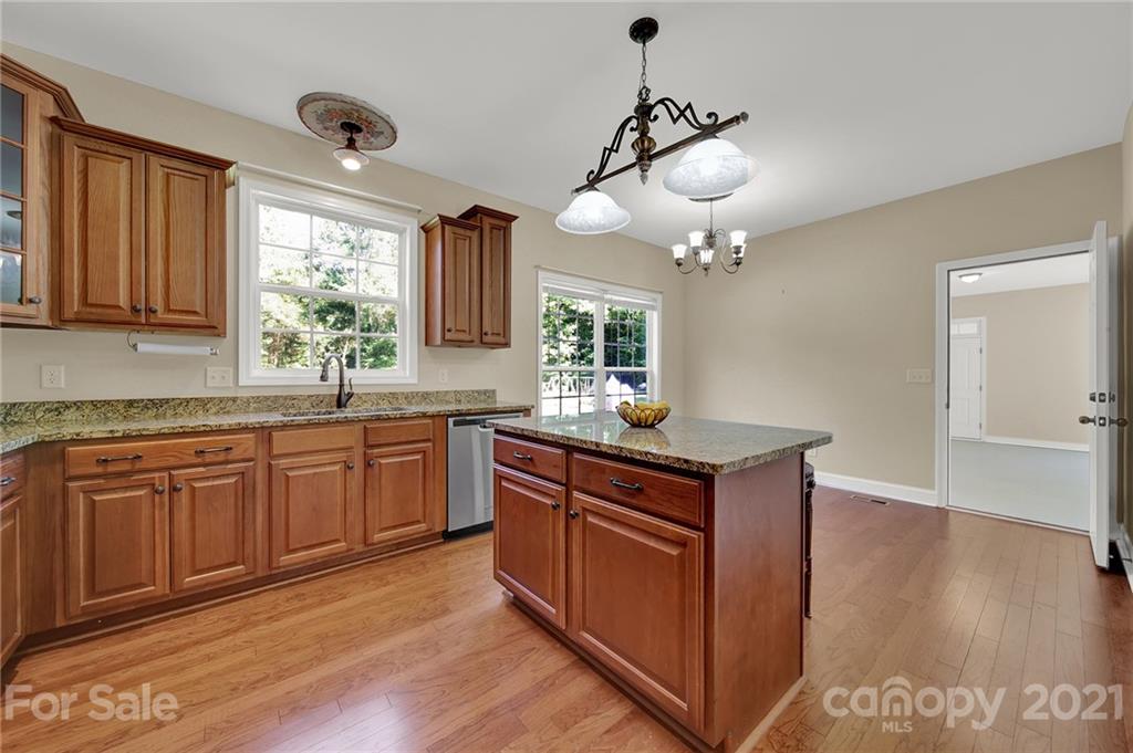 1185 Reservation Road Rock Hill, SC 29730 - Photo 19 of 47 a kitchen with stainless steel appliances granite countertop cabinets and wooden floor