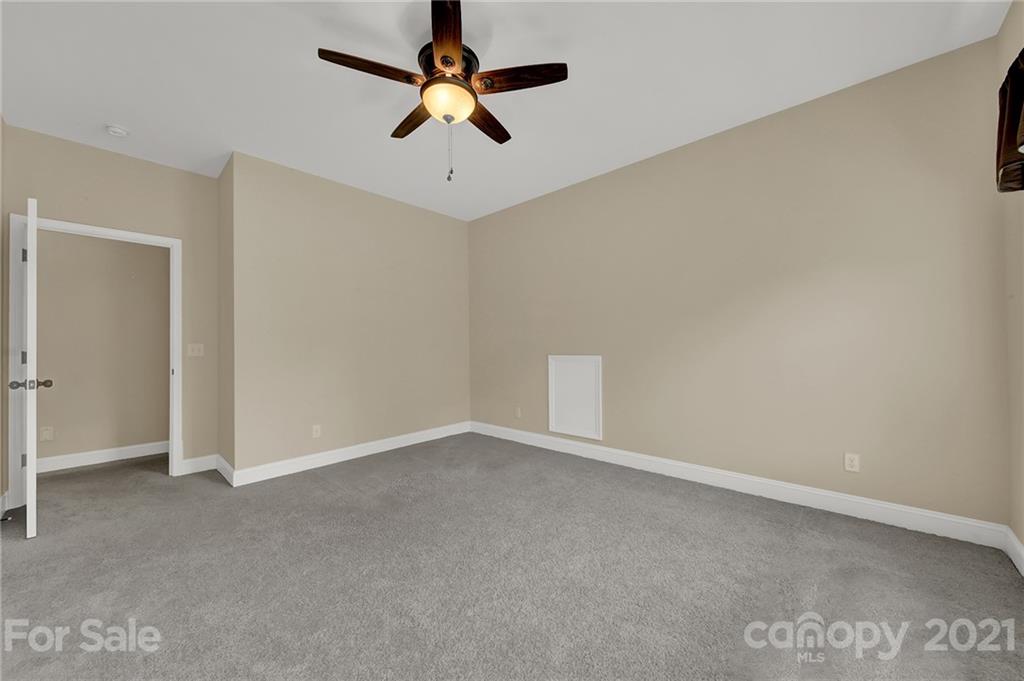 1185 Reservation Road Rock Hill, SC 29730 - Photo 35 of 47 an empty room with a ceiling fan and carpet