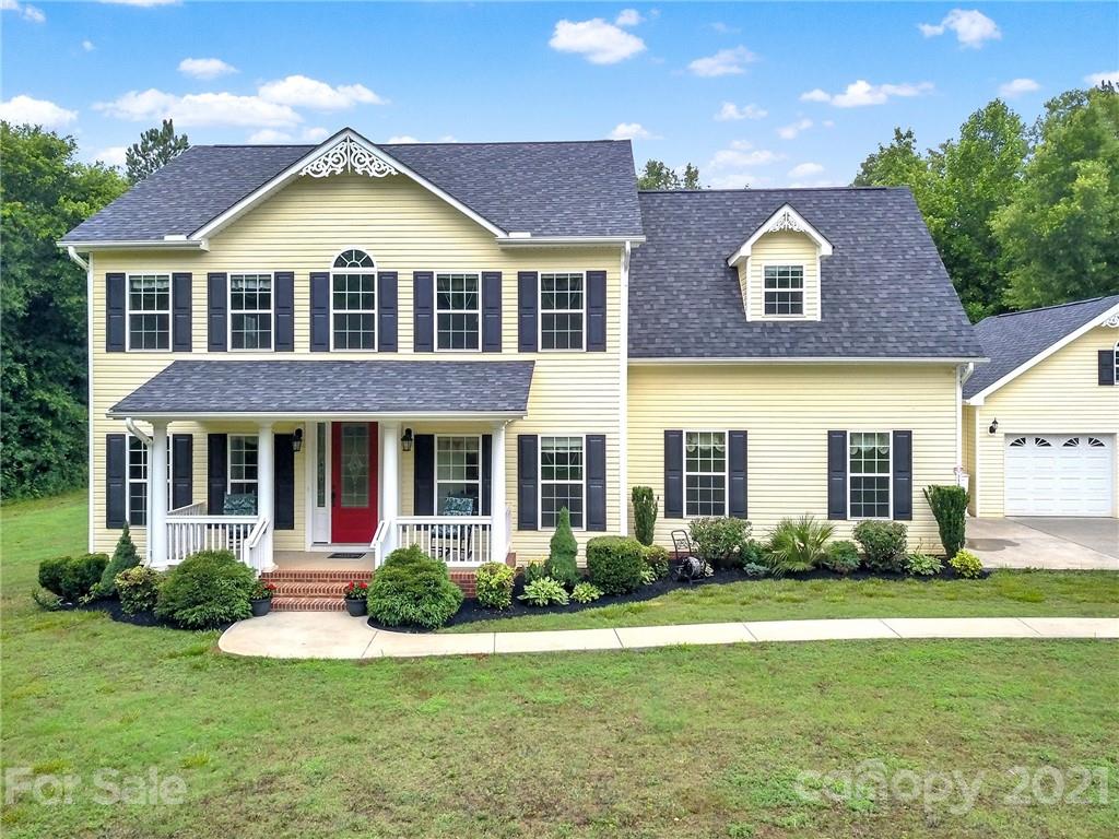 1185 Reservation Road Rock Hill, SC 29730 - Photo 5 of 47 a view of a brick house with a yard lawn chairs and a large tree