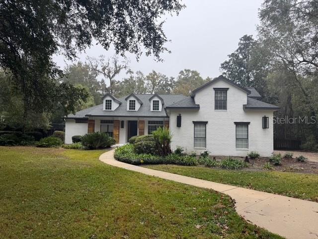 10104 Southwest 17th Place Gainesville, FL 32607 - Photo 1 of 21 a front view of a house with a garden