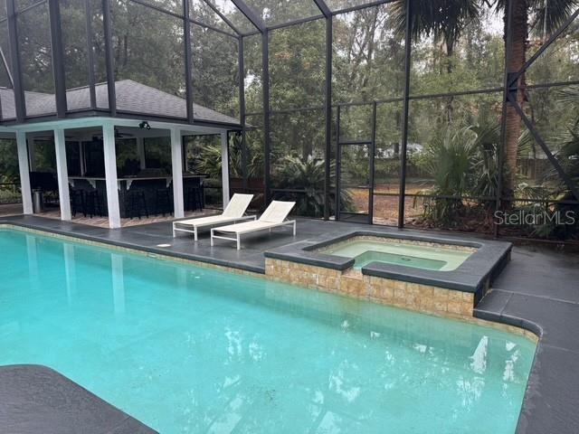 10104 Southwest 17th Place Gainesville, FL 32607 - Photo 16 of 21 a view of a house with swimming pool and porch with furniture