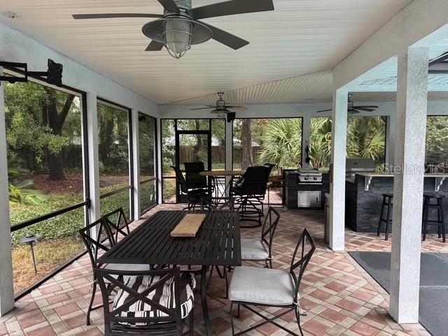 10104 Southwest 17th Place Gainesville, FL 32607 - Photo 18 of 21 a view of a dining room with furniture large windows and wooden floor