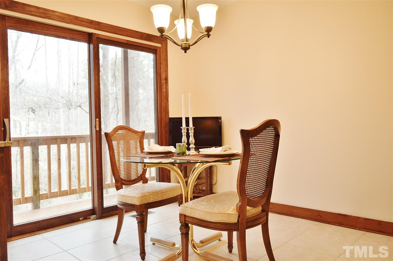 5200 Caber Road Raleigh, NC 27613 - Photo 11 of 25 a view of a dining room with furniture and a window