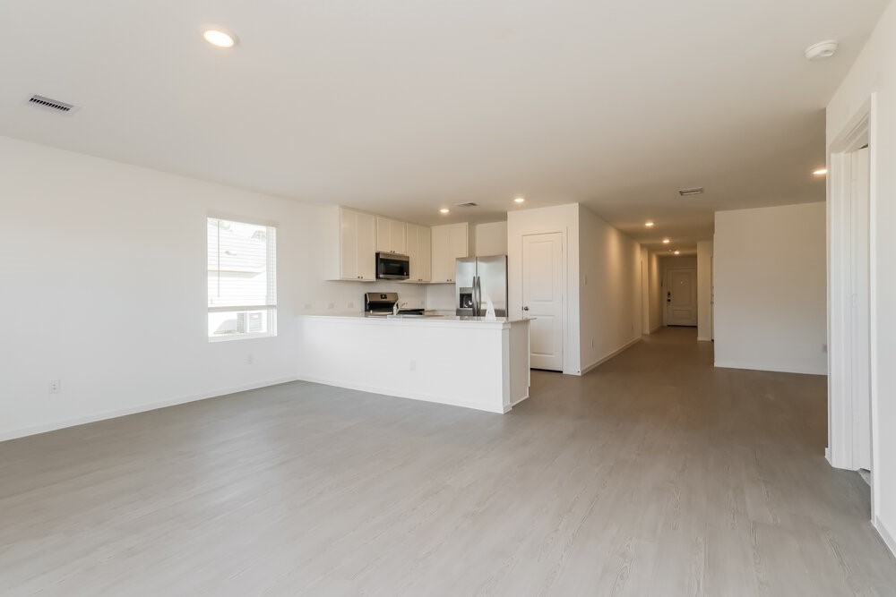 12114 Kellsway Court Conroe, TX 77306 - Photo 4 of 16 a view of a kitchen with a sink and a refrigerator