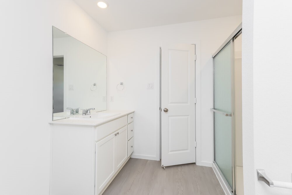 12114 Kellsway Court Conroe, TX 77306 - Photo 10 of 16 a bathroom with a double vanity sink and mirror