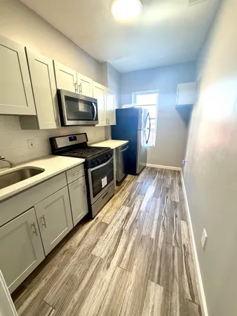 a kitchen with cabinets a sink and a stove top oven
