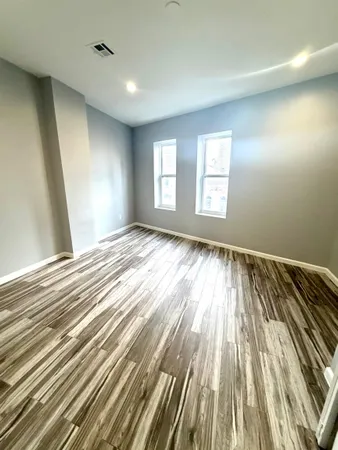 a view of room with window and wooden floor