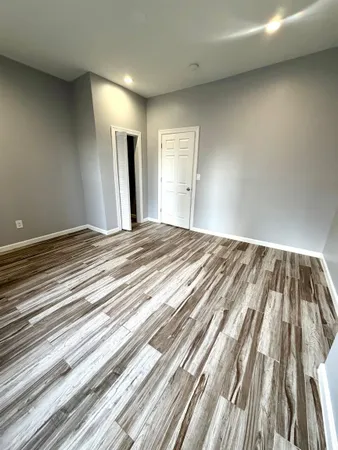 a view of bedroom with wooden floor