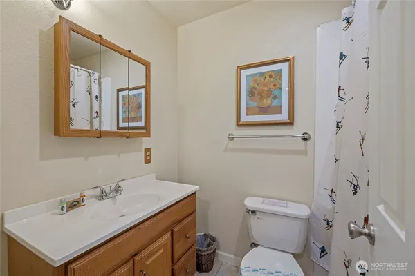 a bathroom with a toilet sink and mirror