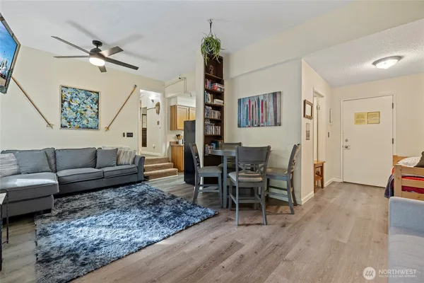 a living room with furniture and wooden floor